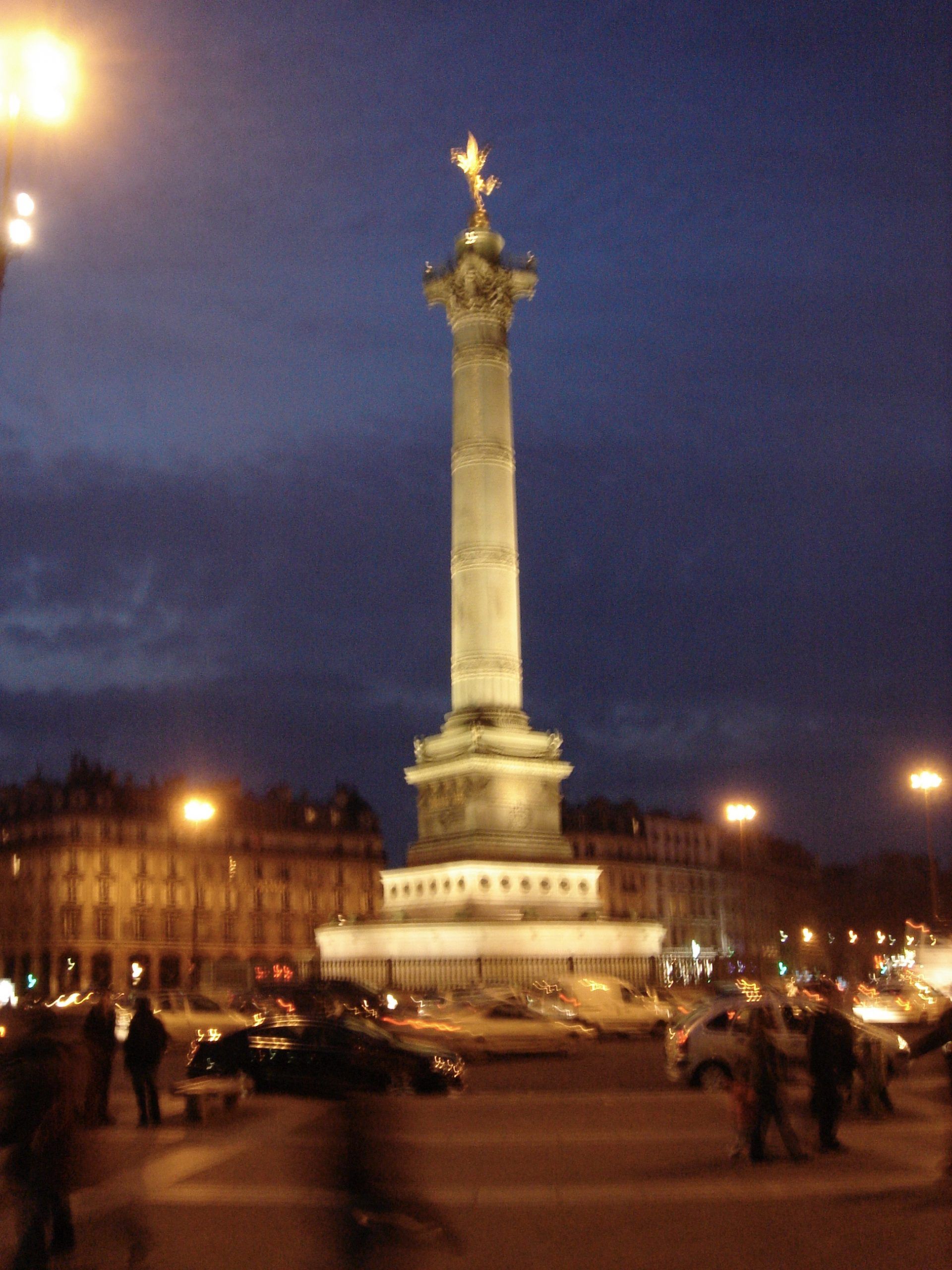 The July Column illuminated at night in the Place de la Bastille.