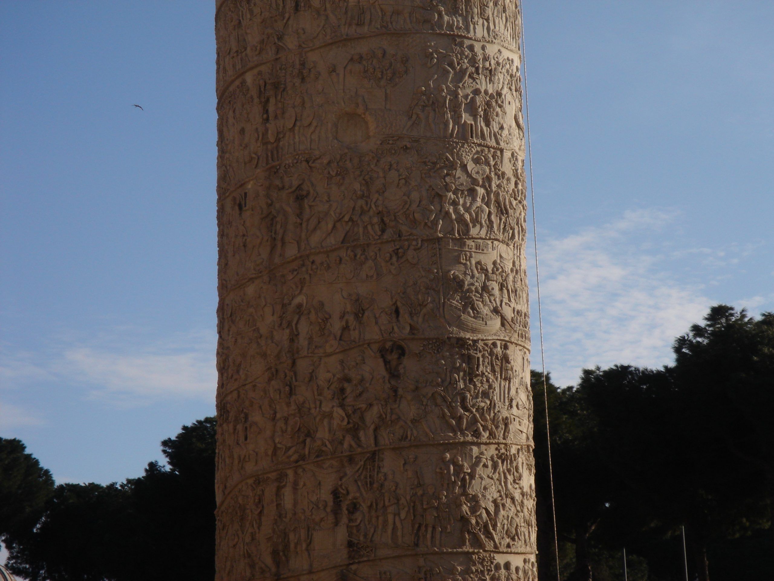 Close-up of the detailed sculpted relief on Trajan’s Column, showing scenes from the Dacian Wars.