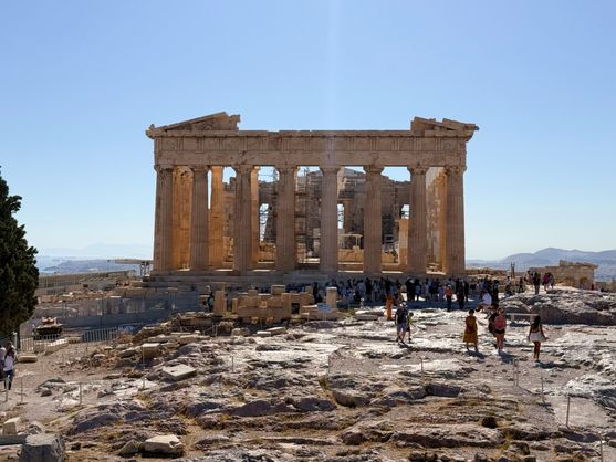 The eastern side of the Parthenon. The pediment is missing and the interior of the temple is covered in scaffolding. It is a blisteringly bright and sunny day.
