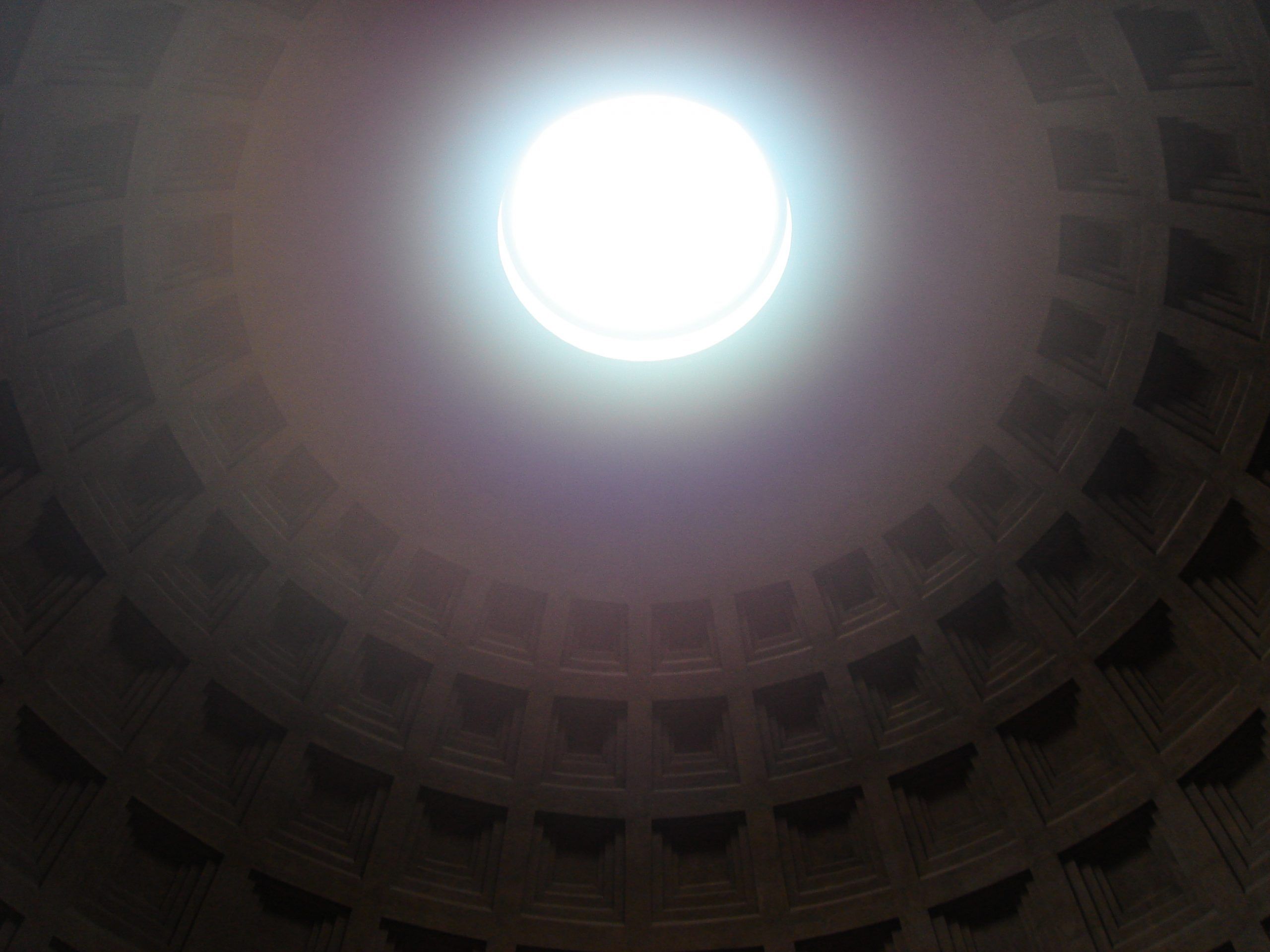 Interior view of the Pantheon’s dome with sunlight streaming through the central oculus.