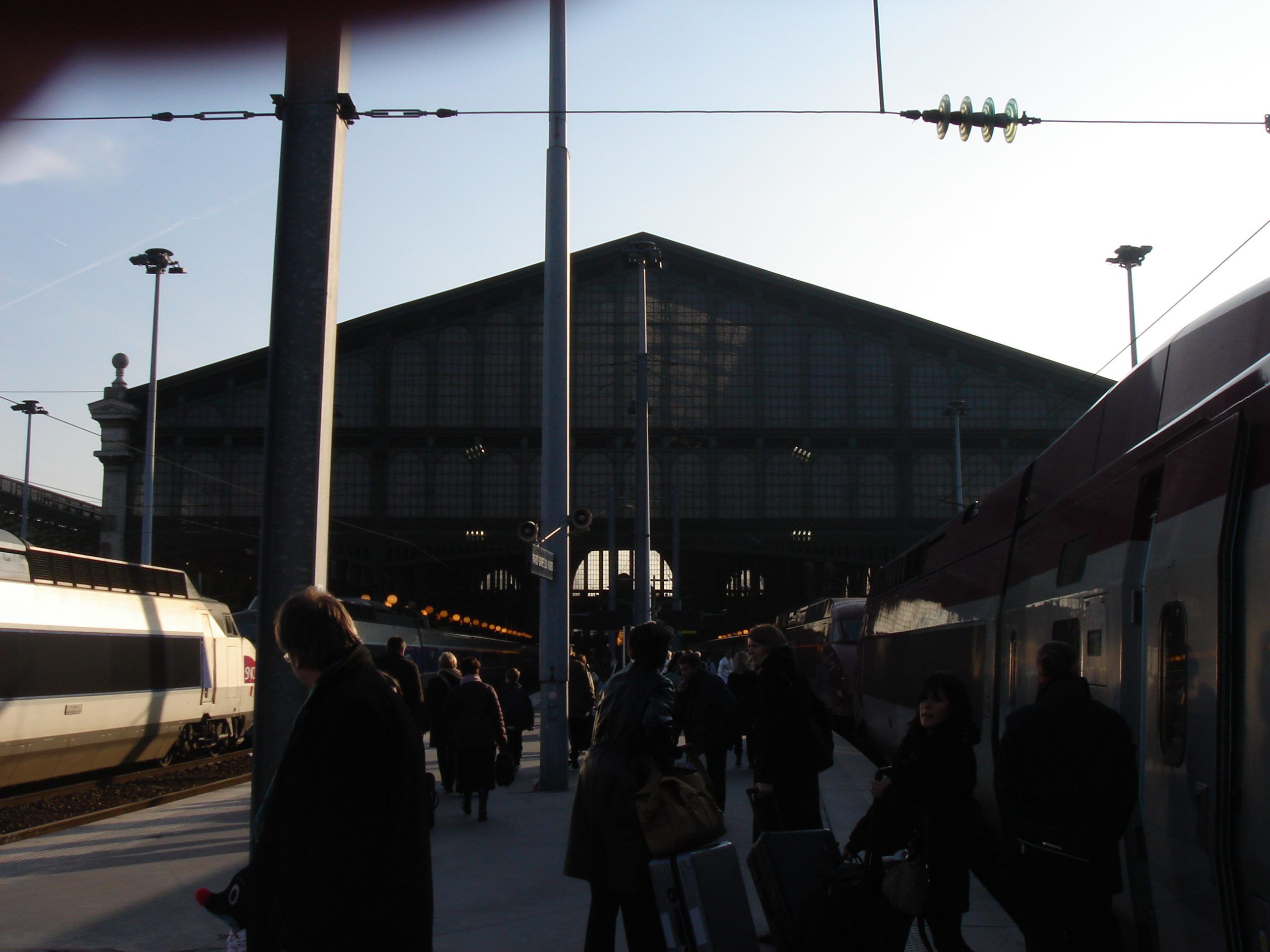 People boarding TGV trains on a platform at Gare du Nord station.