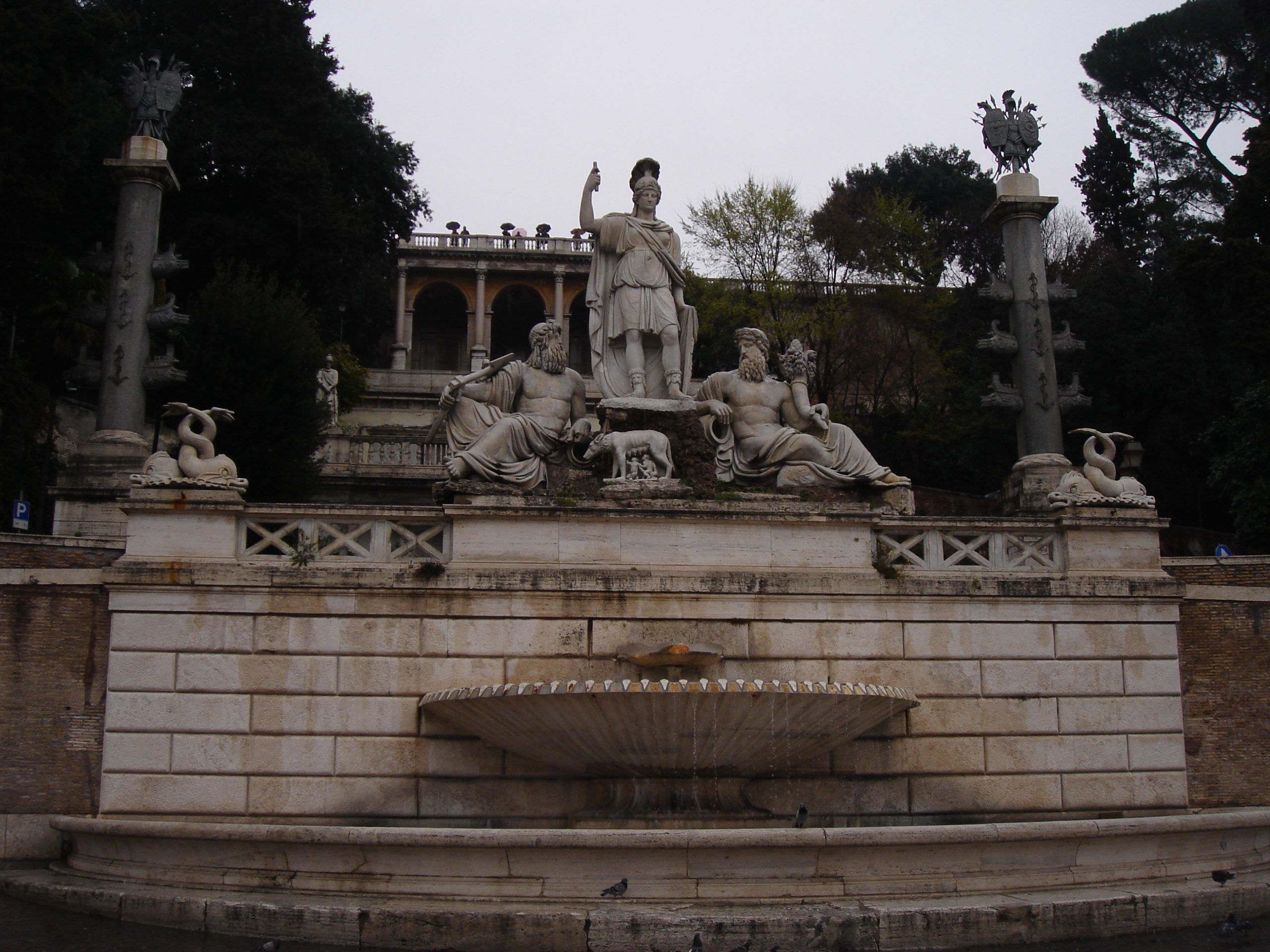 Fountain and sculptural group at the base of the Pincian Hill in Piazza del Popolo, featuring Rome personified between reclining river gods.