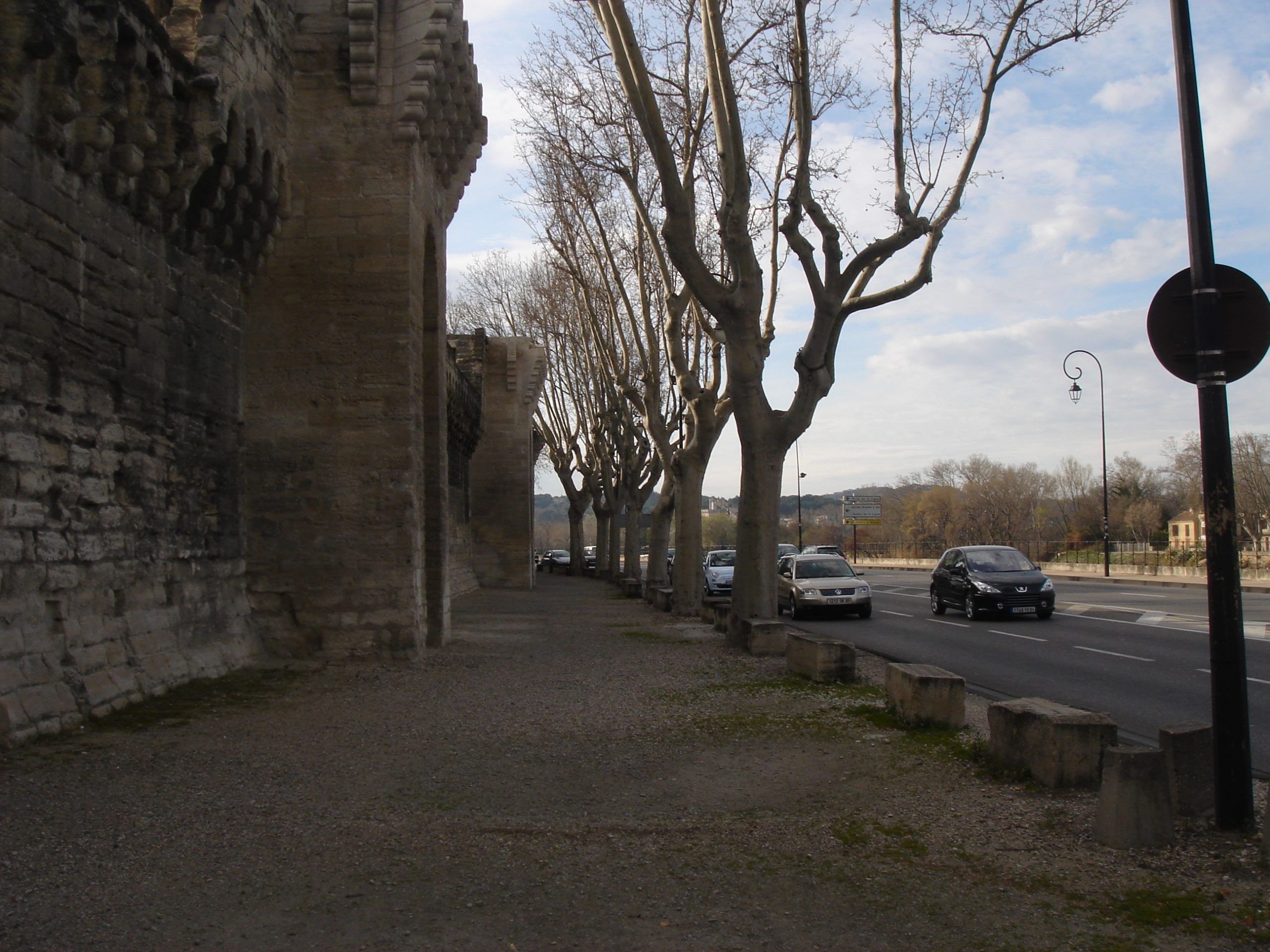 Another angle of the medieval city walls of Avignon, showing their scale and crenellated structure.