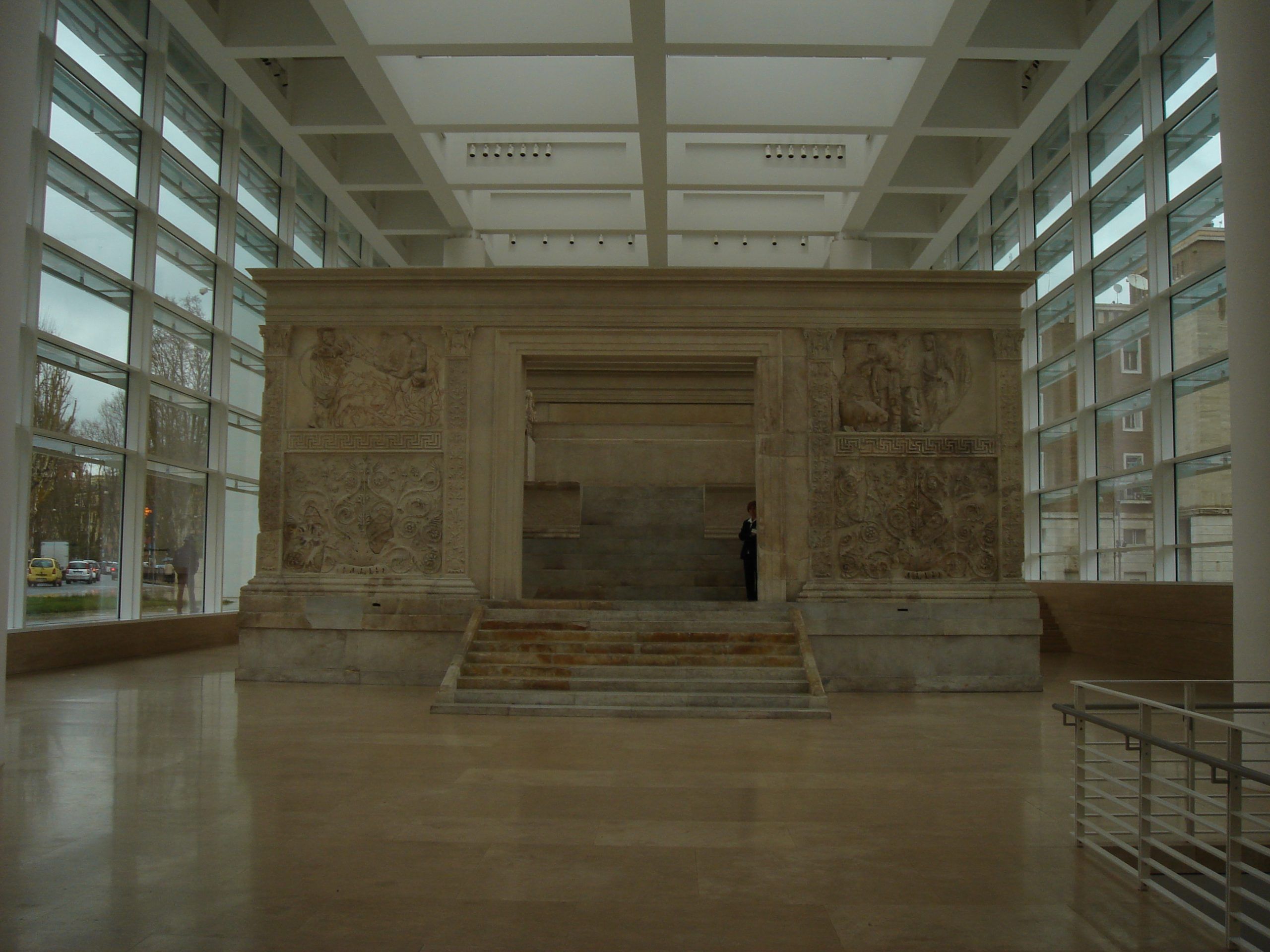 Wide view of the Ara Pacis Augustae inside its modern glass-and-marble museum, with the altar’s carved relief panels clearly visible.