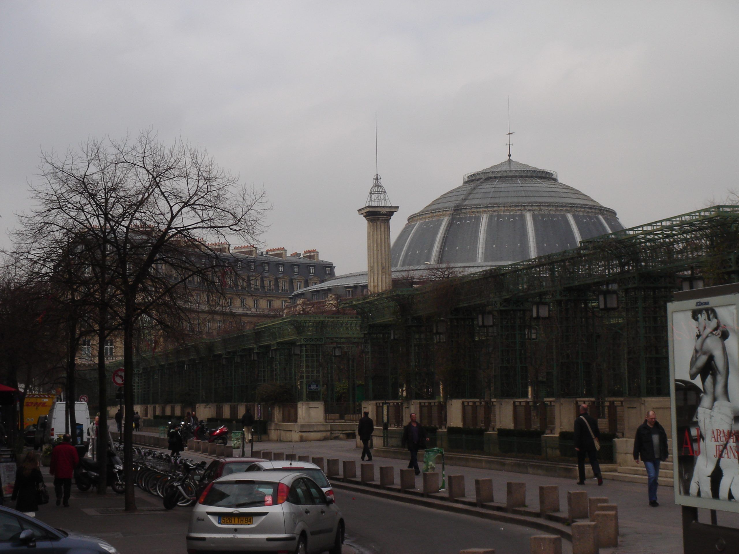 Street view toward the Palais des Congrès in Paris with trees and pedestrians.