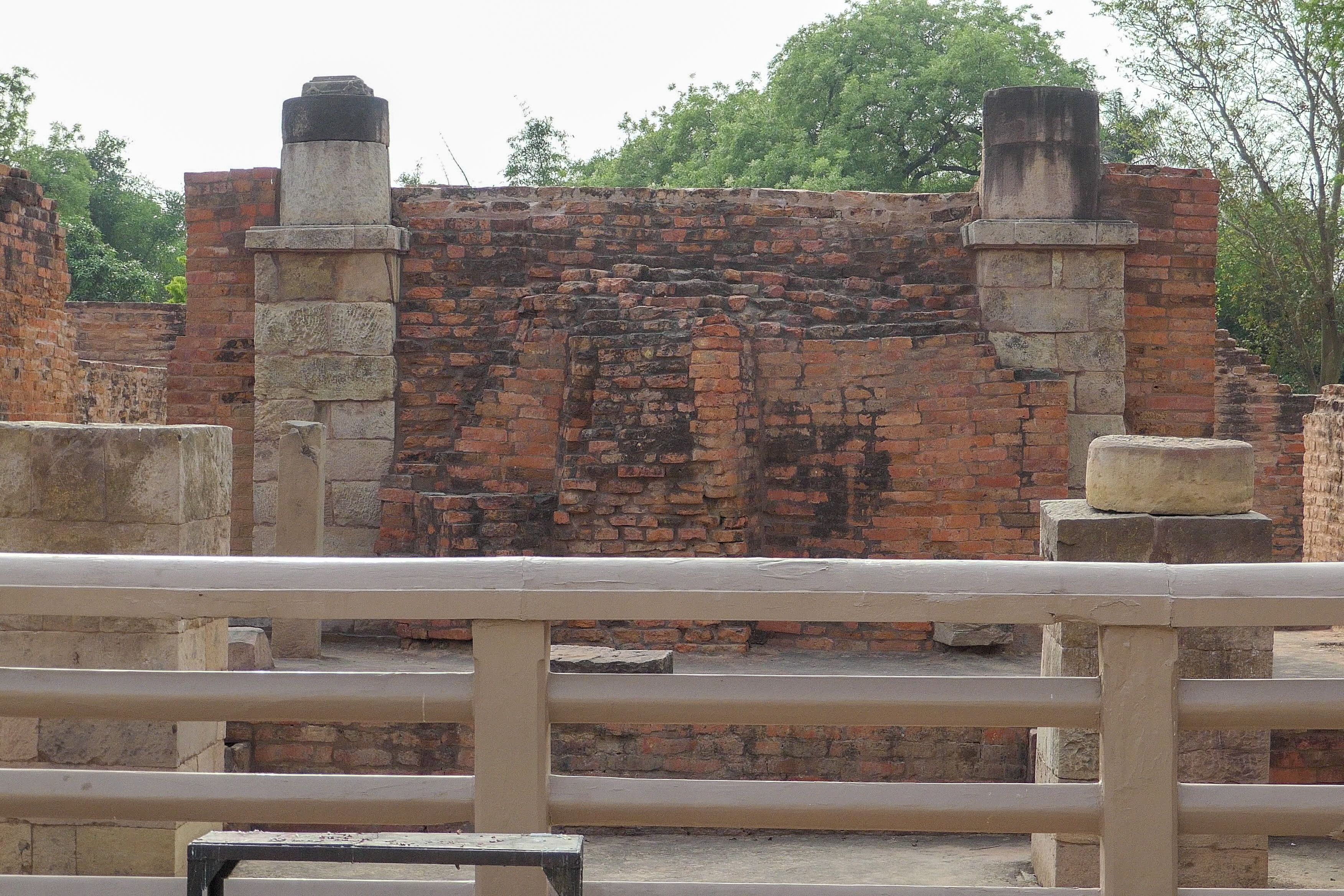 Ruins of ancient brick and stone structures at Sarnath, possibly part of a monastic enclosure or shrine.