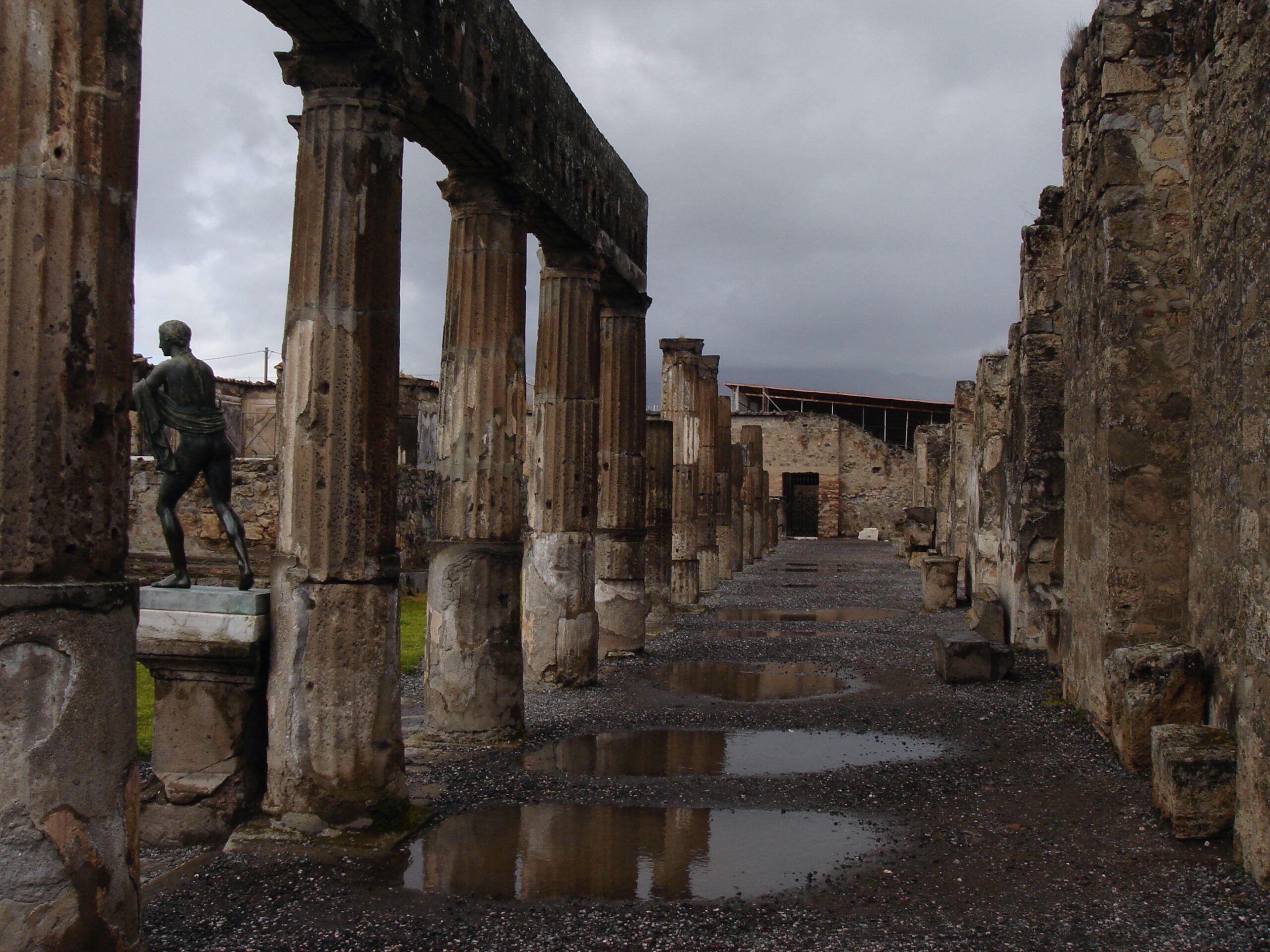 Peristyle courtyard at the Villa of the Mysteries, viewed from within the shadowy interior of the house.