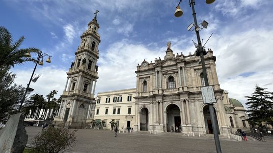 A large church with a tall bell-tower to the left of it
